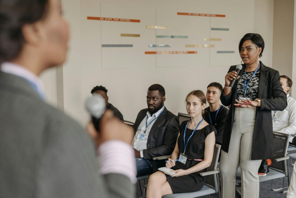 Engaged business discussion at a conference with diverse professionals participating.